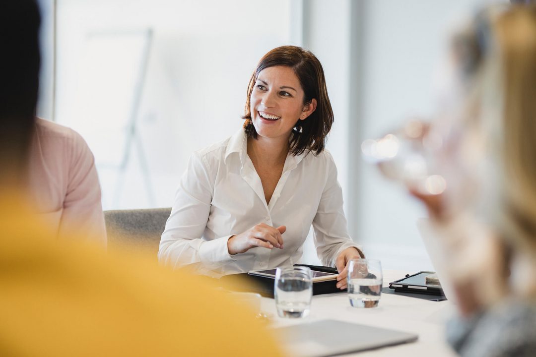 Woman smiling at a desk